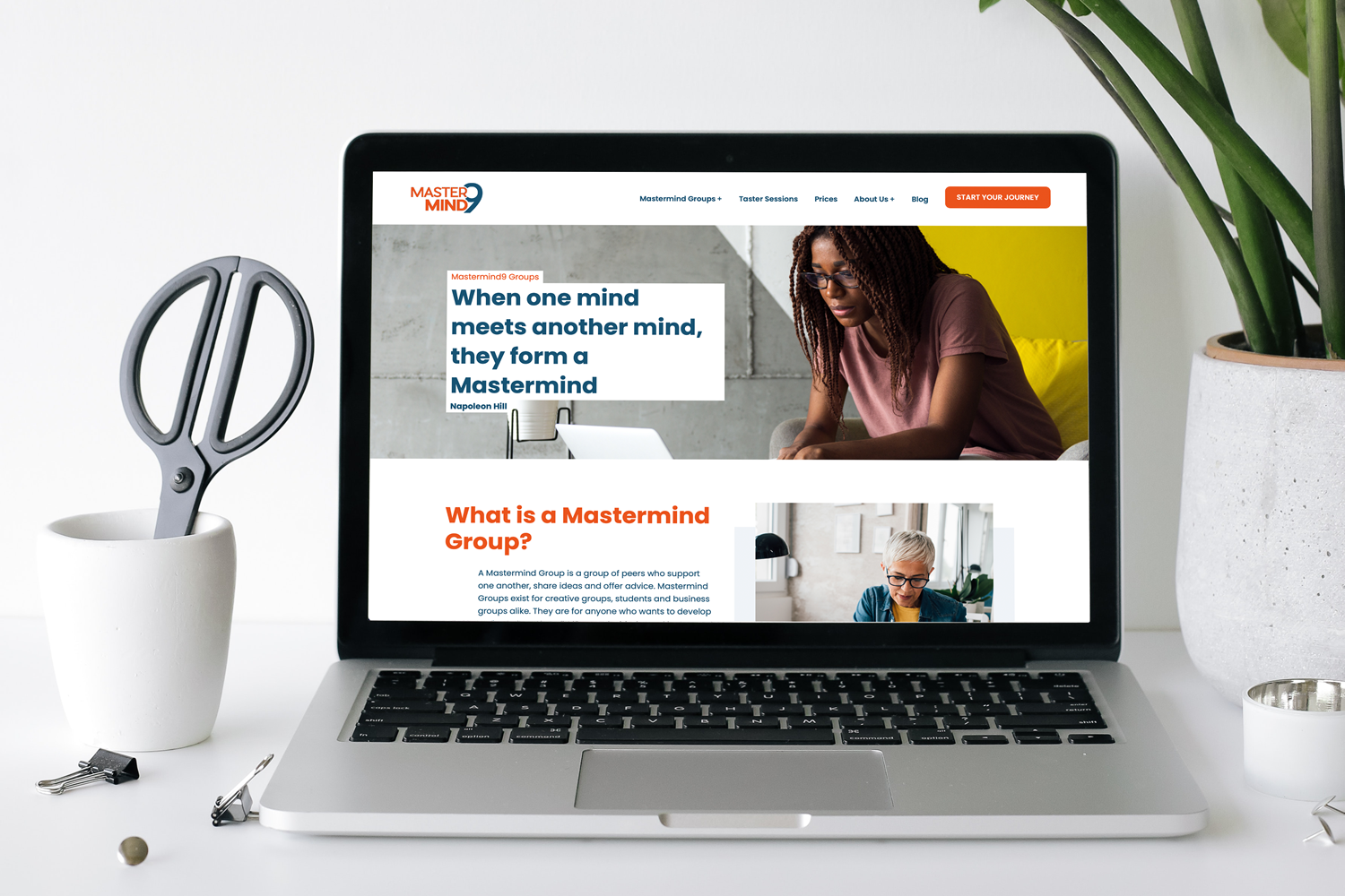 Laptop displaying Mastermind website homepage featuring tagline and images of people in professional settings.
