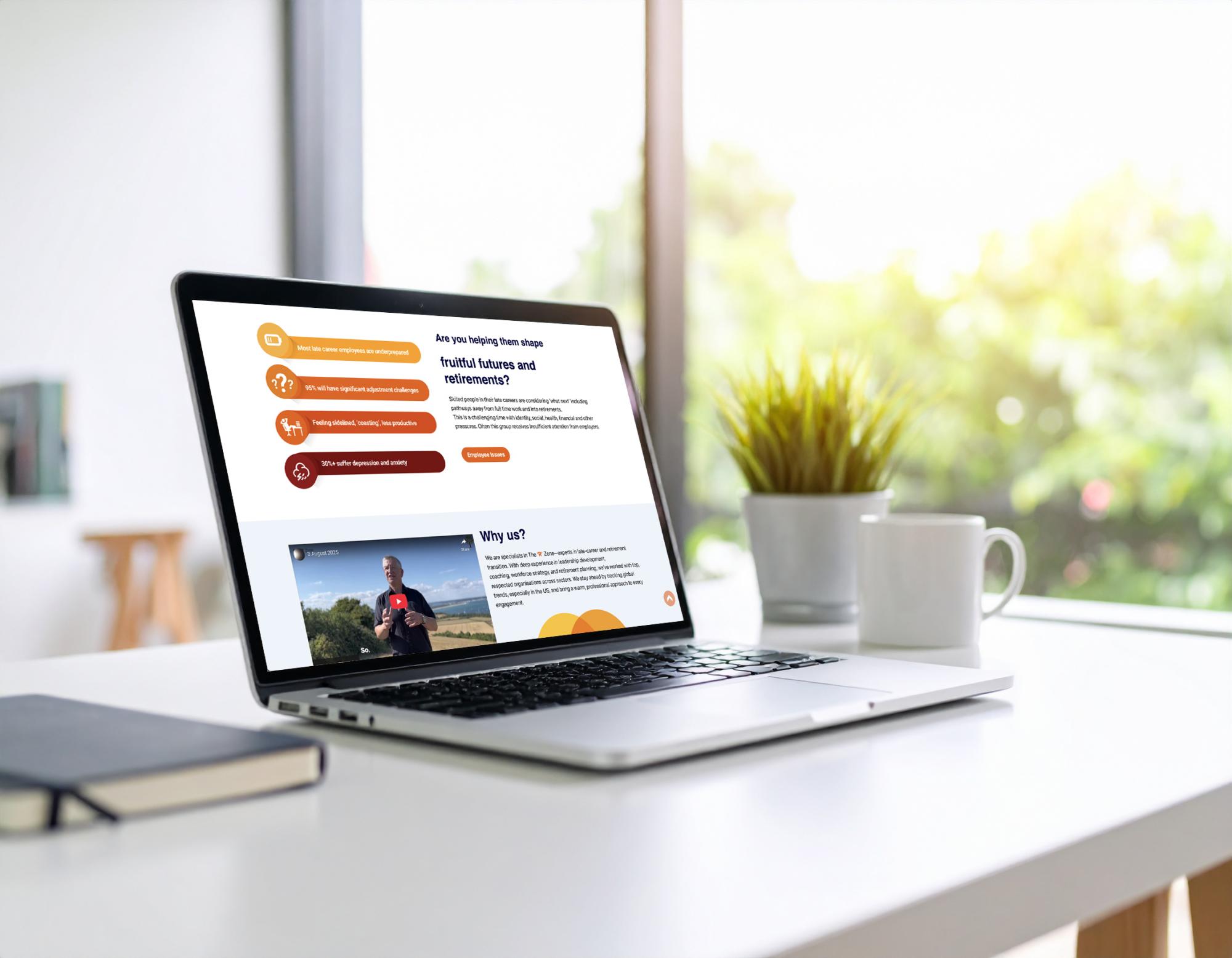 Laptop displaying a bespoke website with orange accents, numbered steps and Why Us section on bright desk.